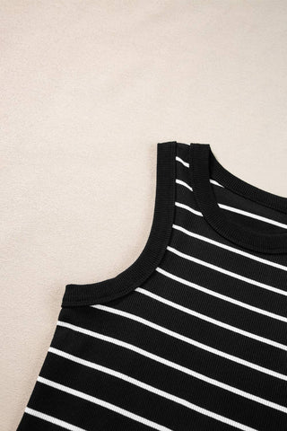 Close-up of the Kannon Stripe Ribbed Knit Tank Mini Dress in black and white, by Little Daisy Closet. The fabric appears to be soft and ribbed, perfect for a casual summer day. The background is a light beige surface.
