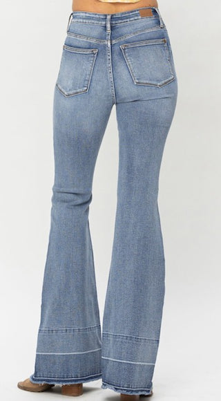 A person is wearing the Western Edge Boutique Townes High Waisted Tummy Control Judy Blue Flares, light blue jeans with back pockets, paired with brown heeled shoes.