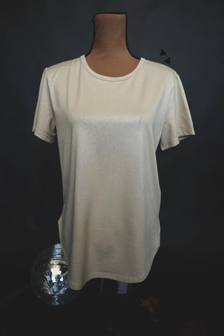 A beige Swanky Faux Leather Cotton Shirt by 2 Fly is displayed on a headless, arm-free mannequin against a dark, nondescript background. The fabric appears soft and the shirt features a classic round neckline with a relaxed fit, epitomizing comfy integrity.