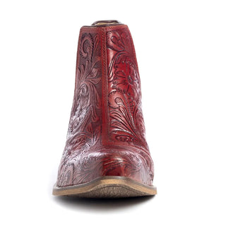 Front view of a single, richly detailed, Moxie Hand-tooled Booties in Scarlet by Myra, featuring intricate floral and leaf engravings. The boot stands on a light tan sole against a plain white background.