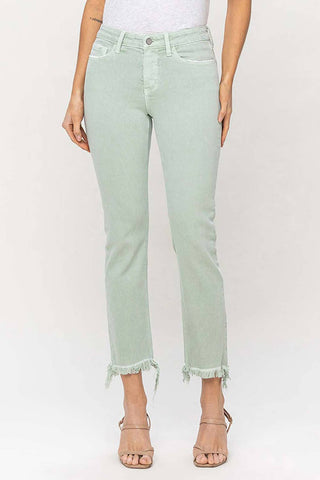 A person wearing Kyler Mid-Rise Slim Straight Jeans by VERVET by Flying Monkey in a mint color, crafted from soft cotton with a distressed hem and silver button and zipper closure, stands against a plain background. The jeans feature front and back pockets and are paired with beige open-toe heels. The upper part of the person is not visible.