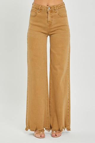 A person wearing Risen's Caliber Camel High Rise Wide Pants with a frayed hem. The person is also wearing open-toe sandals. The photo is cropped just below the shoulders, focusing on the pants.